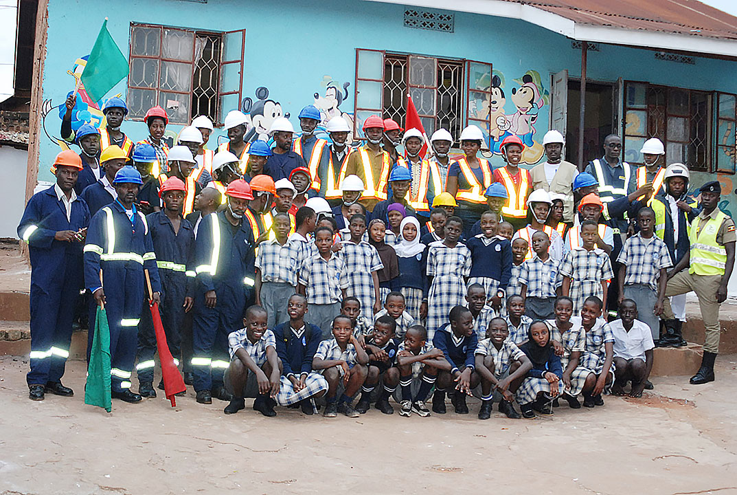 Epsilon Africa Staff posing with Vallerian Nursery Primary School Pupils
